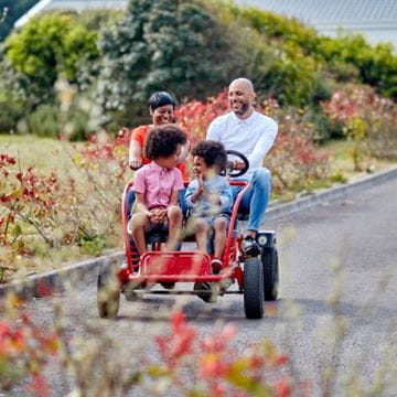 a family riding in a kart