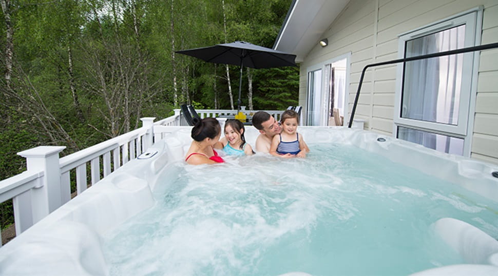 A family relaxing in their lodge hot tub