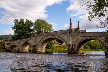 Stony bridge over rippling water