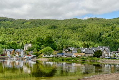 Woodland and small village bordering a clear lake