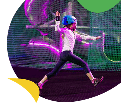 A girl using the Bounce Below activity near Ty Mawr Holiday Park