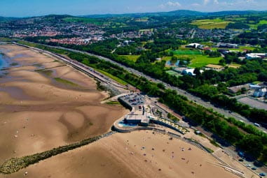 Leafy seaside town with large sandy beach