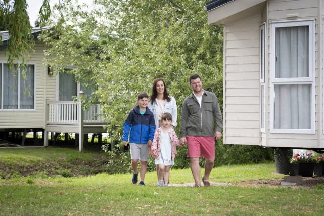 Family walking outside park home at Valley Farm