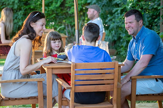 A family enjoying an al fresco meal at the restaurant at Valley Farm Holiday Park