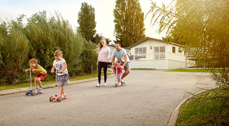 family on scooters on the holiday park path