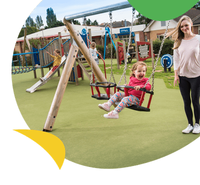 A girl being pushed on the swing at Weeley Bridge Holiday Park