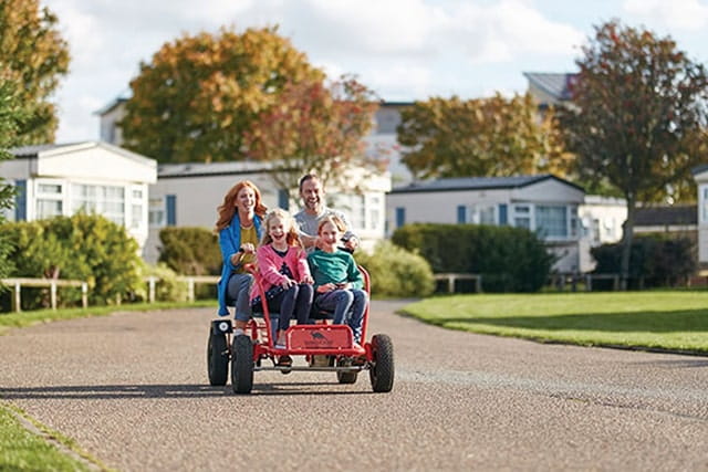 family riding a large kart