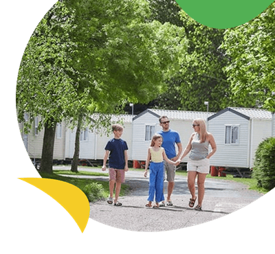 Family walking outside park homes at Vauxhall Holiday Park