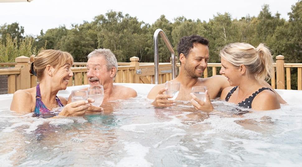 two couples relaxing in a hot tub