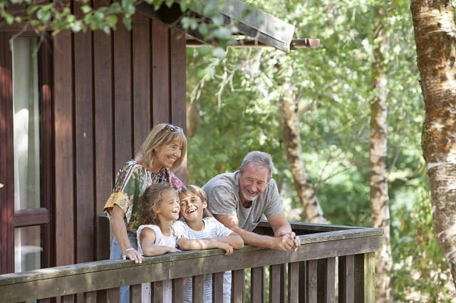 Grandparents and grand children on a holiday lodge veranda