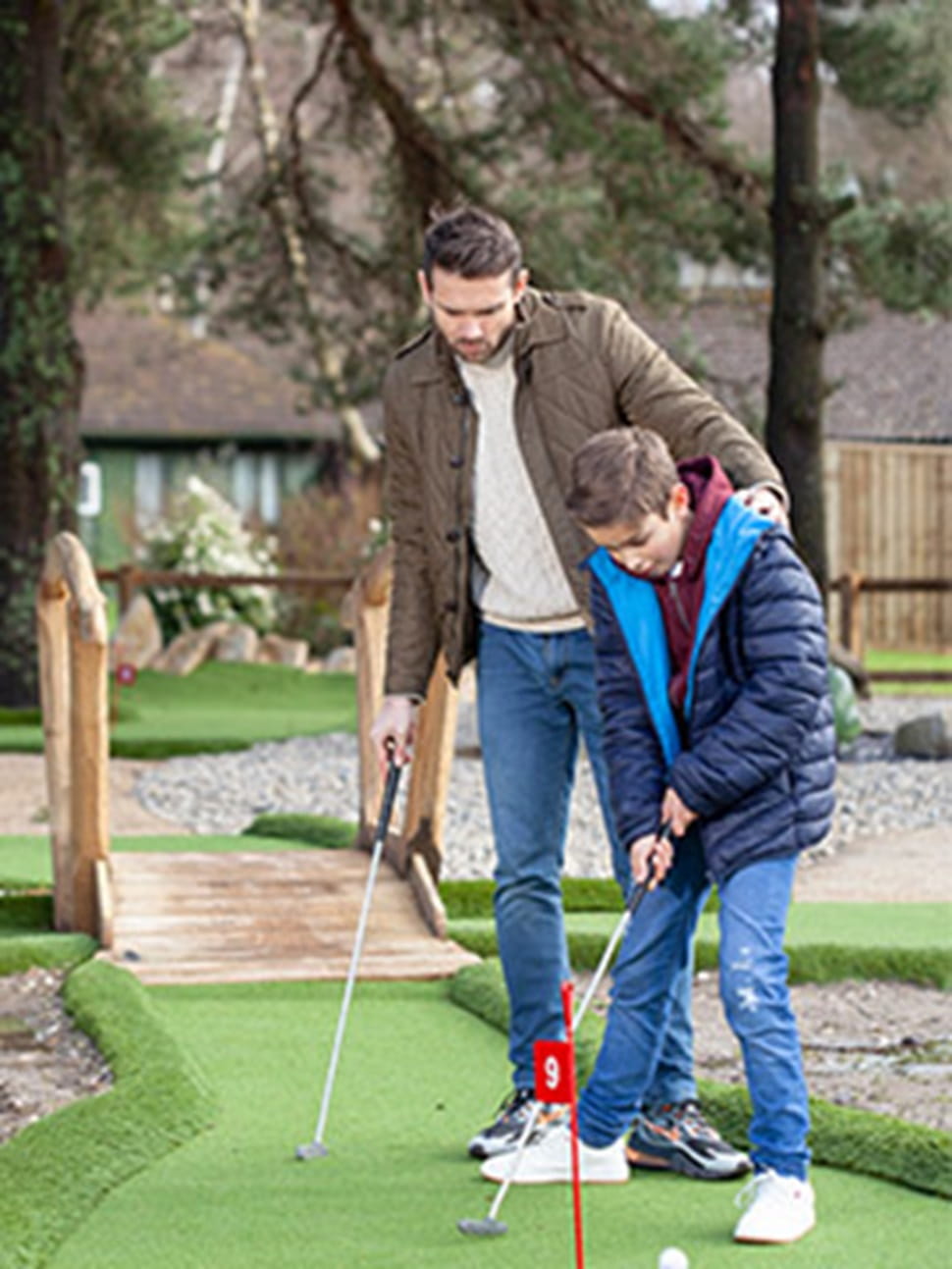 father and son playing crazy golf