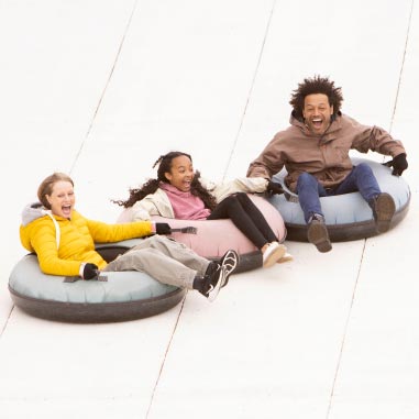 a family sliding on rubber rings
