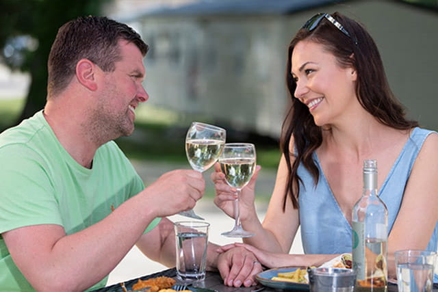 A couple enjoying food and drinks in the restaurant