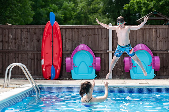 A boy jumping in the outdoor pool at Weeley Bridge Holiday Park