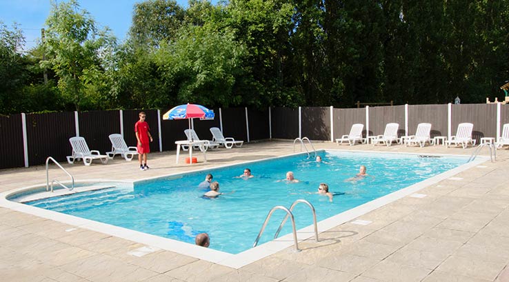 people playing in the outdoor pool at Weeley Bridge Holiday Park