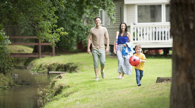 A family walking around Weeley Bridge Holiday Park