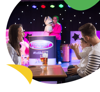 A family watching an entertainment show at Weeley Bridge Holiday Park