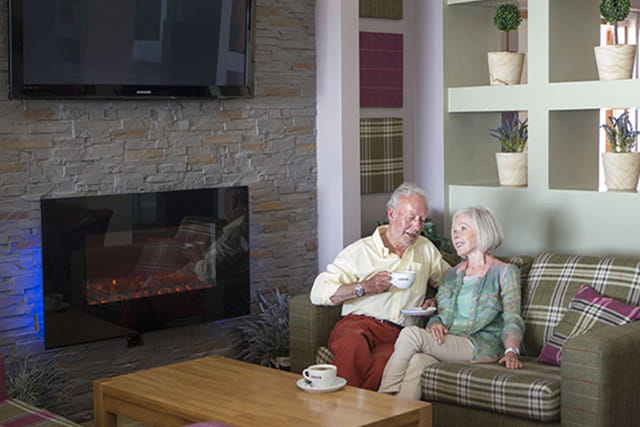 Grandparents relaxing with a Costa Coffee in the bar at Wemyss Bay Holiday Park