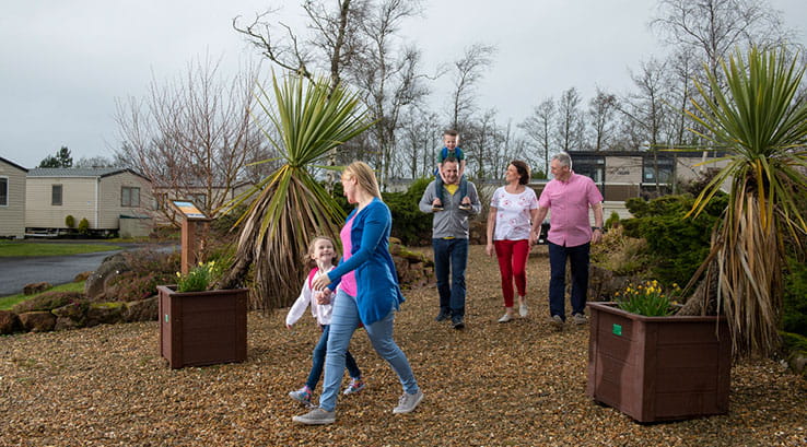 A family strolling through the grounds at Wemyss Bay Holiday Park
