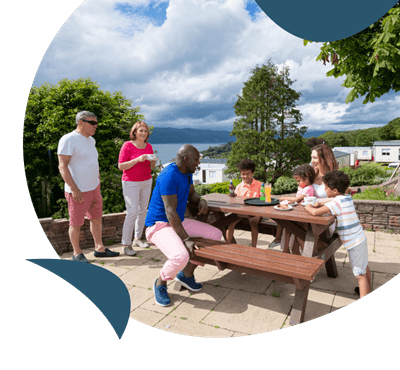 A family dining outdoors at Wemyss Bay holiday park
