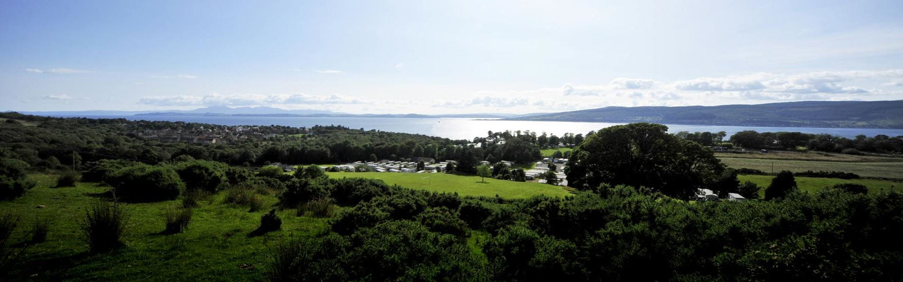 Green countryside with a view of the sea