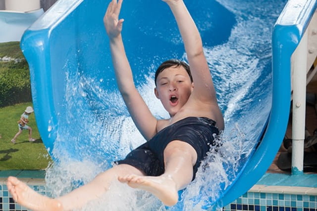 Boy on water slide