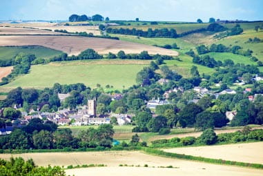 A town nestled in rolling green hills