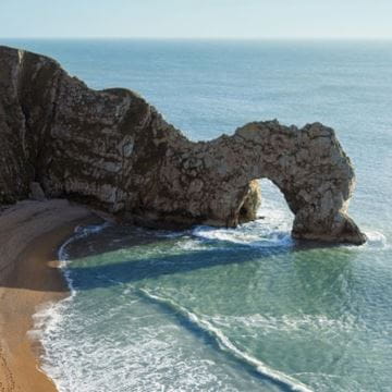a rock formation stretching out into the sea