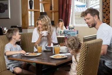 a family enjoying a meal in a restaurant