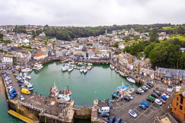 A busy fishing harbour full of boats in Padstow Cornwall