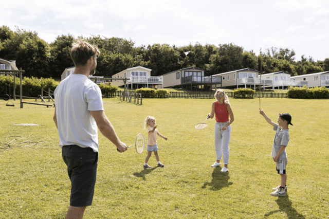 Family playing badminton at White Acres