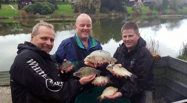 three fishermen showing of their catch