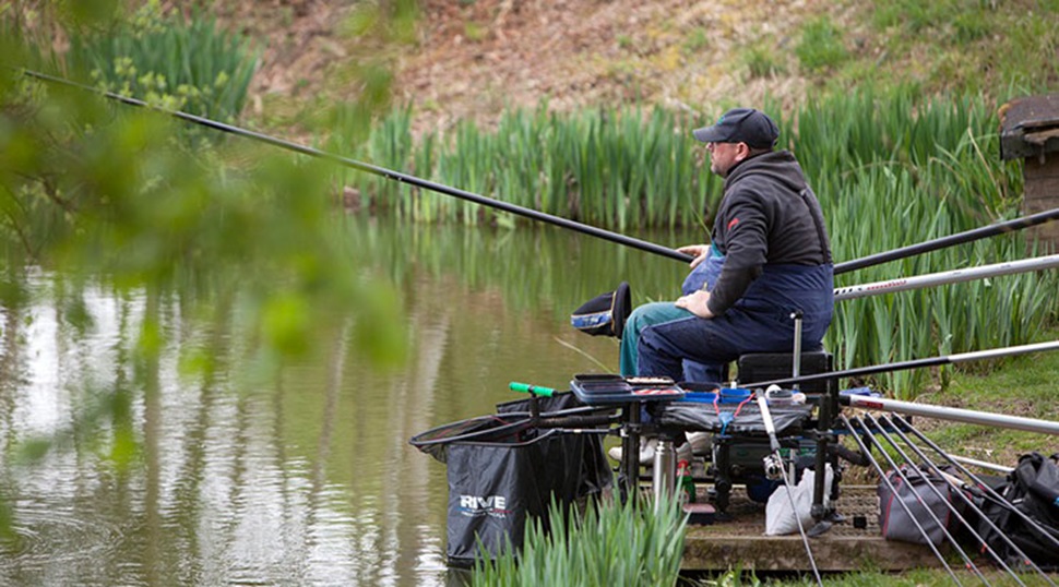 angler fishing by a lake
