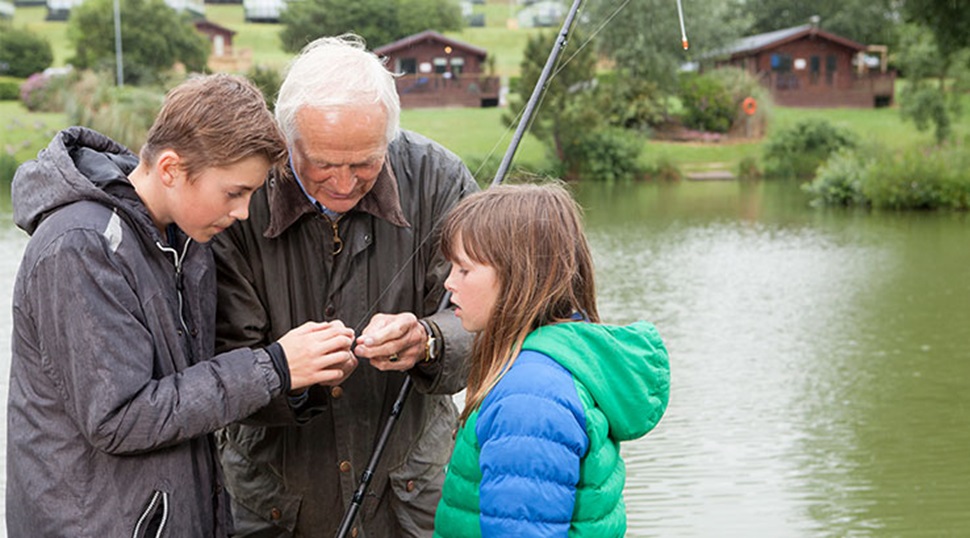 grandfather and grandchildren preparing for fishing