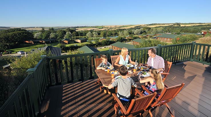 Family sat around a table on holiday