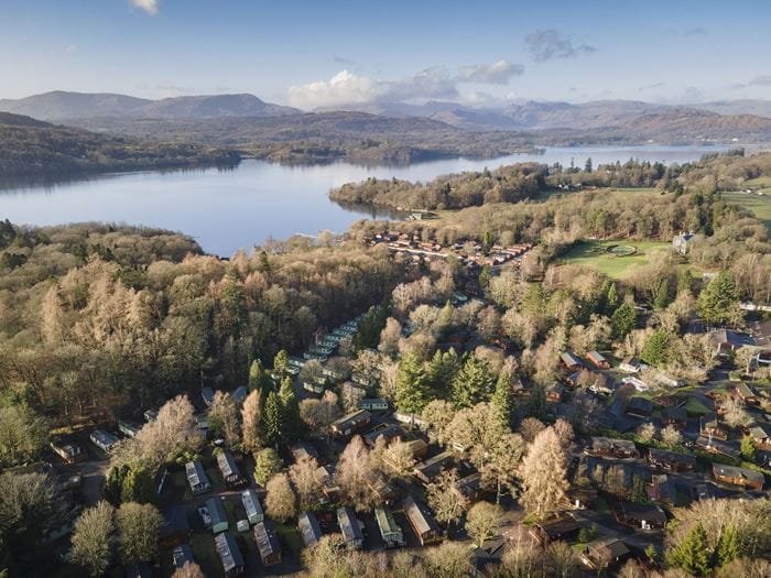 An aerial view of White Cross Bay Holiday park, surrounding lake and mountains