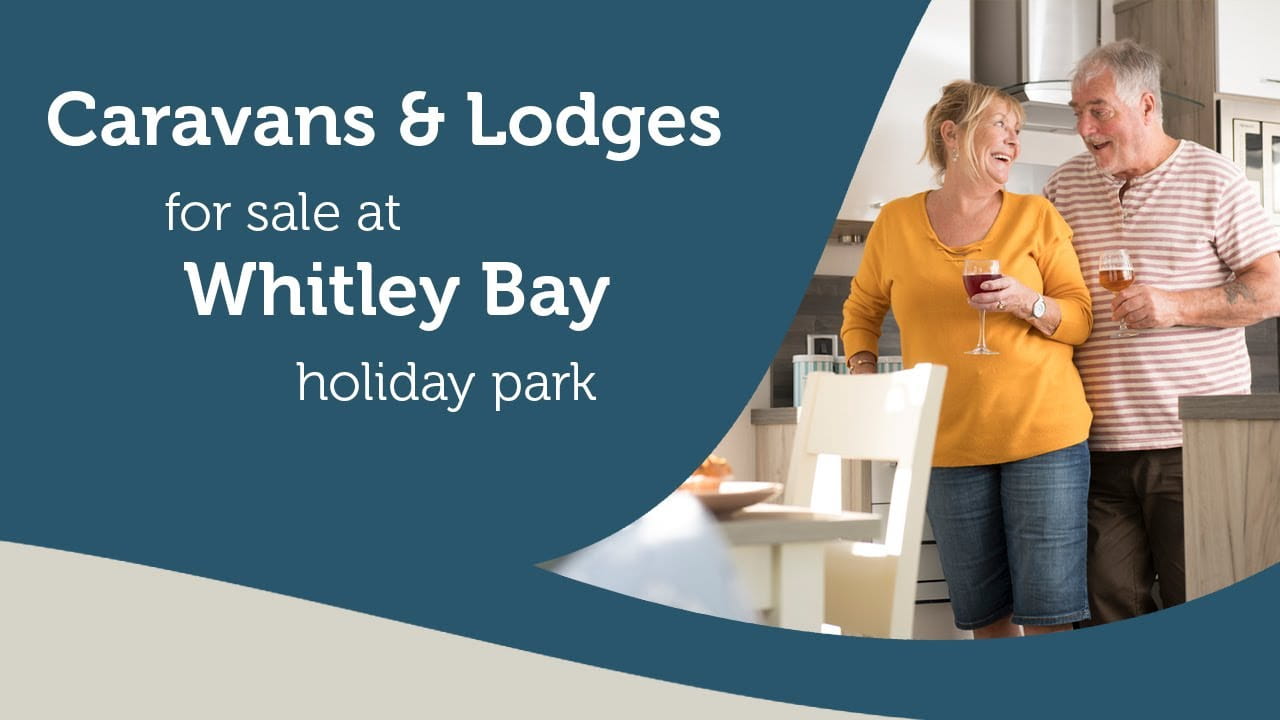 A couple drinking wine within their holiday home at Whitley Bay Holiday Park