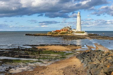 a lighthouse surrounded by blue seas