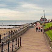 People walking along a coastal path