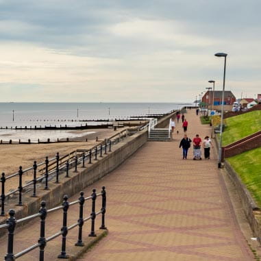 People walking along a coastal path