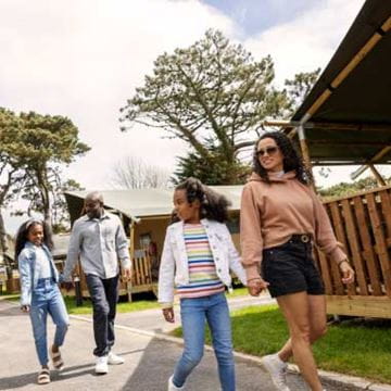 family walking by glamping tent