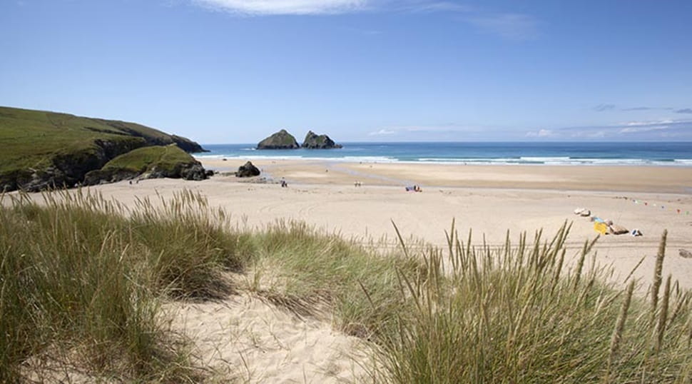A view of a sandy beach in Cornwall from the dunes