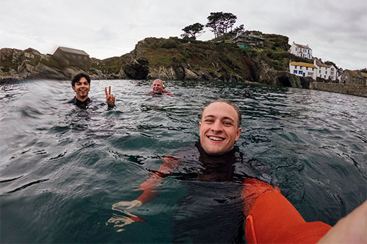 A group of friends trying a coasteering activity in Cornwall