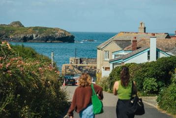 Couple walking towards the beach