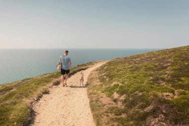 Man and dog hiking the South West Coast Path