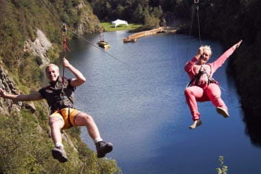 Couple ziplining at Adrenaline Quarry