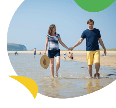 Couple walking on the beach in Cornwall