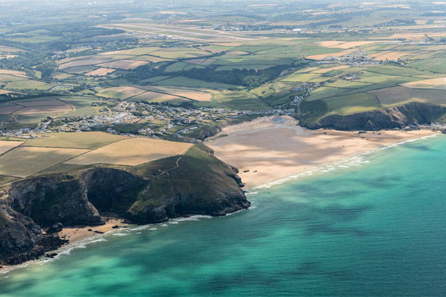 An aerial view over Mawgan Porth on the Cornwall coast