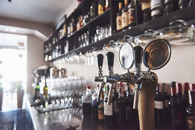 A bar with glasses and beer pumps