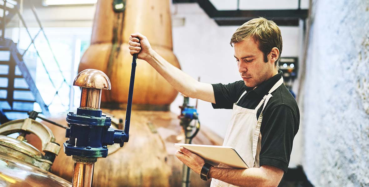 A man working in a beer distillery